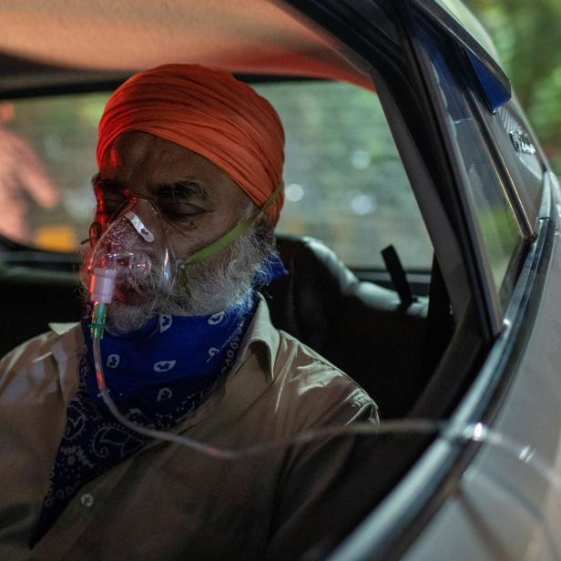 A man with a breathing problem receives oxygen support for free at a Gurudwara, in Ghaziabad