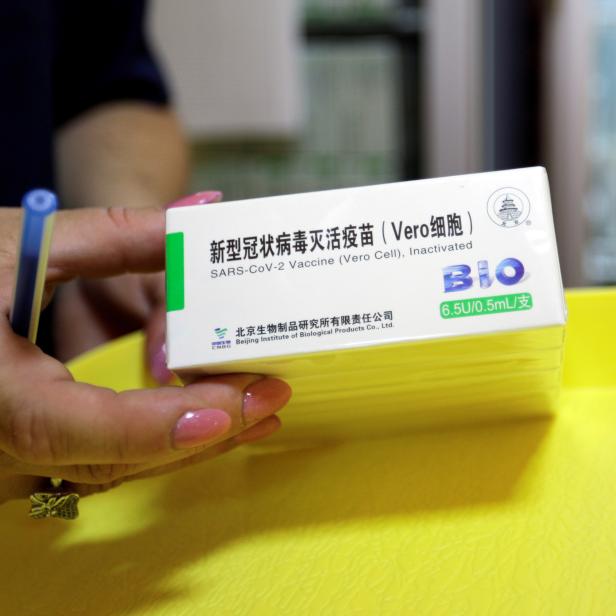 FILE PHOTO: A healthcare worker handles China's Sinopharm coronavirus disease (COVID-19) vaccines at a sport centre in Stip