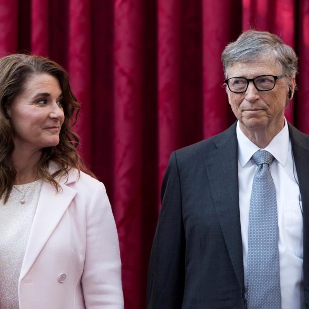 FILE PHOTO: Philanthropist and co-founder of Microsoft, Bill Gates and his wife Melinda listen to the speech by French President Francois Hollande, prior to being awarded Commanders of the Legion of Honor at the Elysee Palace in Paris