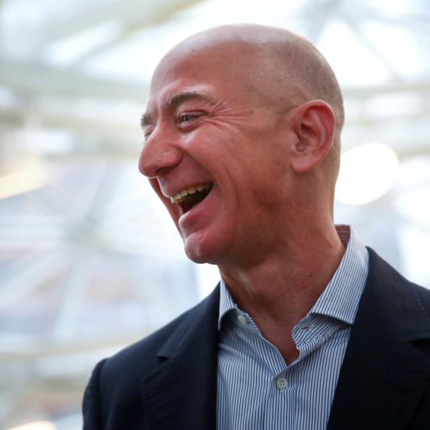 FILE PHOTO: Amazon founder and CEO Jeff Bezos laughs as he talks to the media while touring the new Amazon Spheres during the grand opening in Seattle