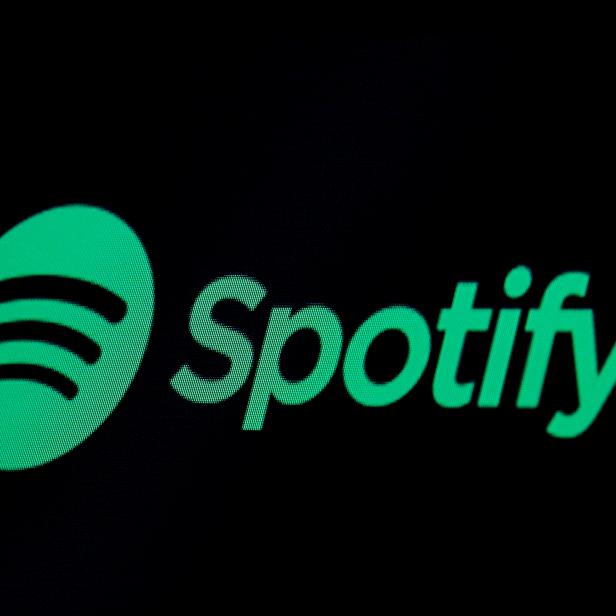 FILE PHOTO: FILE PHOTO: The Spotify logo is displayed on a screen on the floor of the NYSE in New York