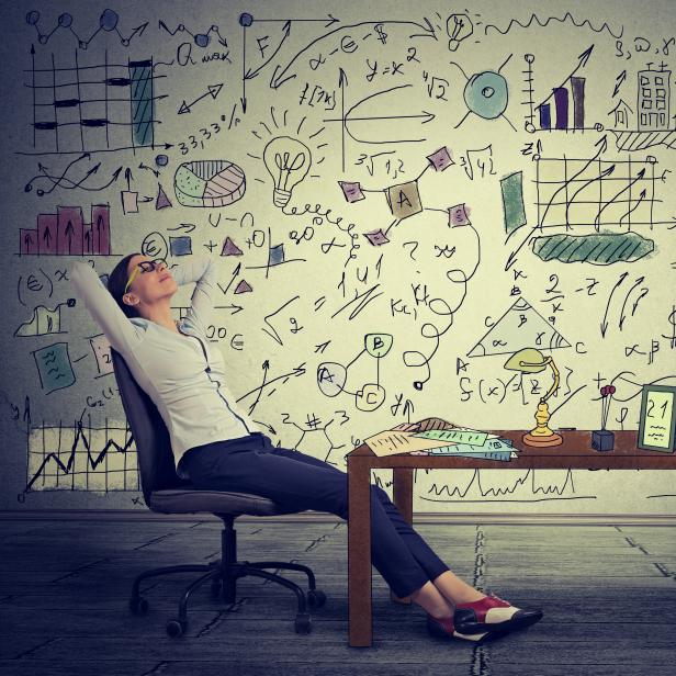 Young business woman relaxing at her desk in her office