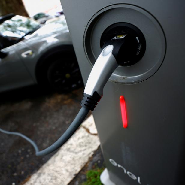 FILE PHOTO: FILE PHOTO: An electric car is plugged in at a charging point for electric vehicles in Rome
