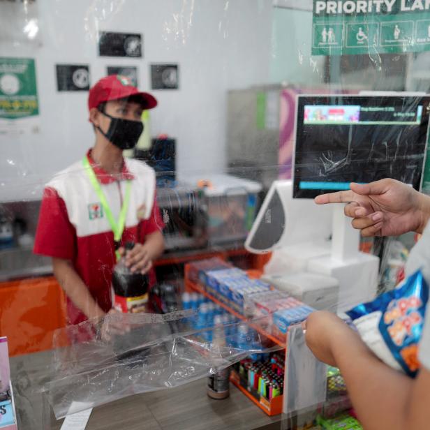 FILE PHOTO: Shops install a makeshift plastic barrier as a protection from coronavirus disease, in Quezon City