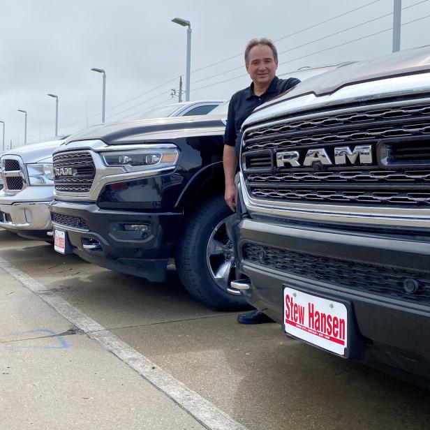 FILE PHOTO: Jerry Bill, general manager of Stew Hansen Chrysler Dodge Jeep Ram, poses among a line of Ram trucks in Urbandale