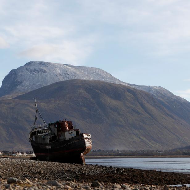 The wreck of the Golden Harvest, a fishing vessel that ran aground on the banks of Loch Linnhe in 2011, is seen in front of the UK's highest mountain Ben Nevis near Fort William