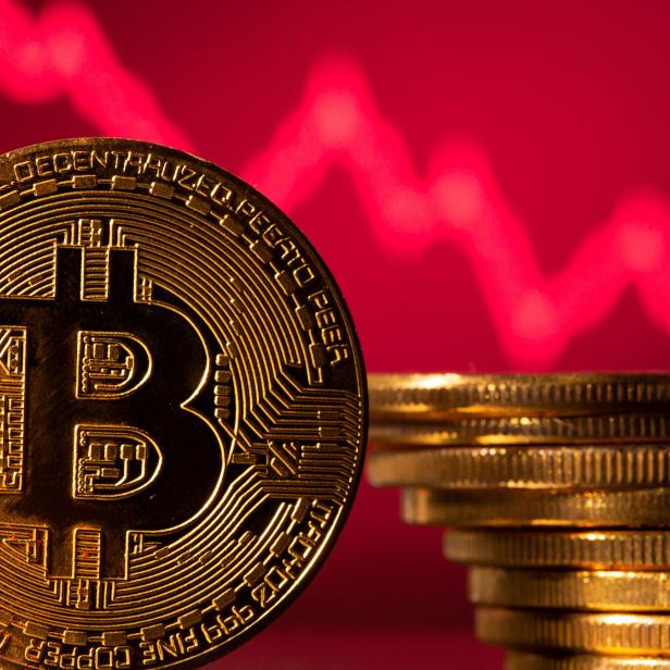 FILE PHOTO: A representations of virtual currency Bitcoin is seen in front of a stock graph in this illustration