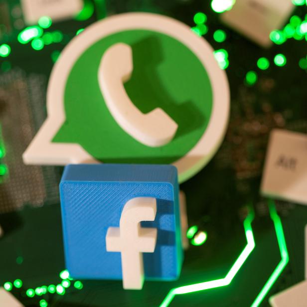 FILE PHOTO: FILE PHOTO: Illustration of 3D printed Facebook and WhatsApp logos and keyboard buttons on a computer motherboard