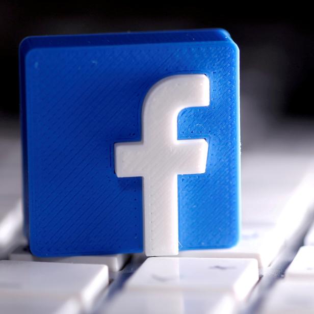 FILE PHOTO: A 3D-printed Facebook logo is seen placed on a keyboard in this illustration