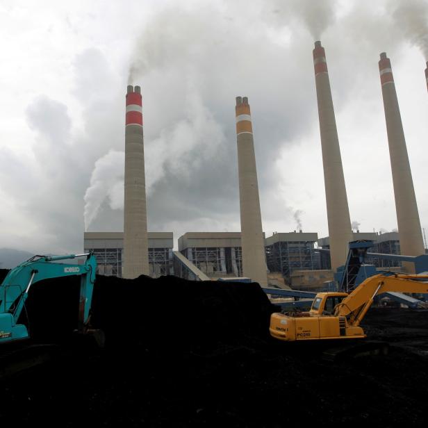 FILE PHOTO: FILE PHOTO: Excavators pile coal in a storage area in an Indonesian Power Plant in Suralaya
