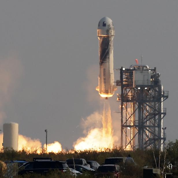 Billionaire businessman Jeff Bezos is launched with three crew members aboard Blue Origin's New Shepard rocket