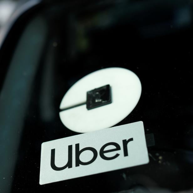 FILE PHOTO: An Uber logo is shown on a rideshare vehicle