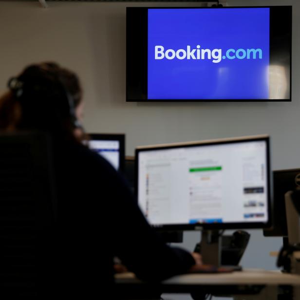 FILE PHOTO: An employee works on his computer at the new Booking.com customers site in Tourcoing