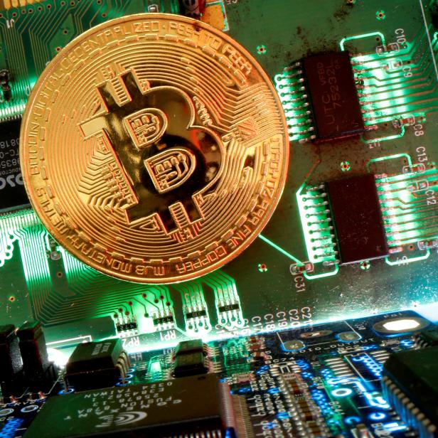 FILE PHOTO: Representation of the virtual currency bitcoin is seen on a motherboard in this picture illustration