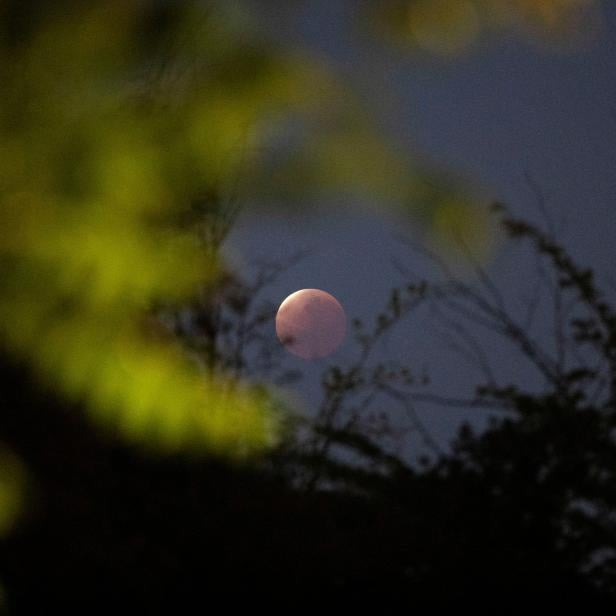 A partial lunar eclipse dubbed the 'blood moon' is seen in Santiago