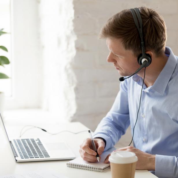 Businessman sitting at workplace improve knowledge using online lessons