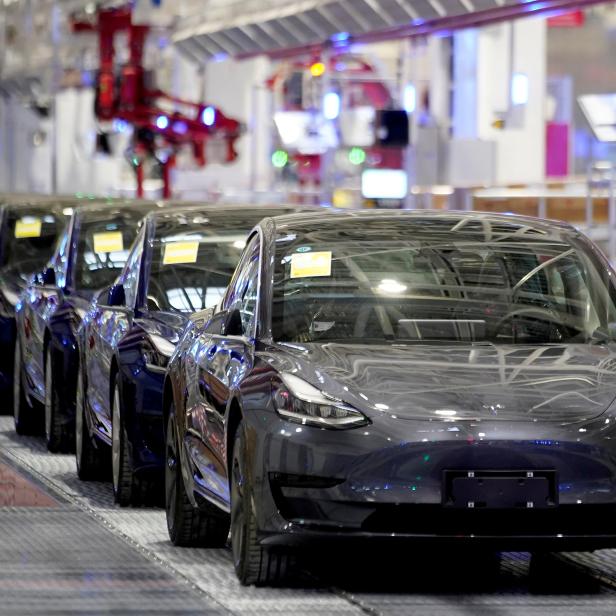 FILE PHOTO: Tesla China-made Model 3 vehicles are seen during a delivery event at its factory in Shanghai