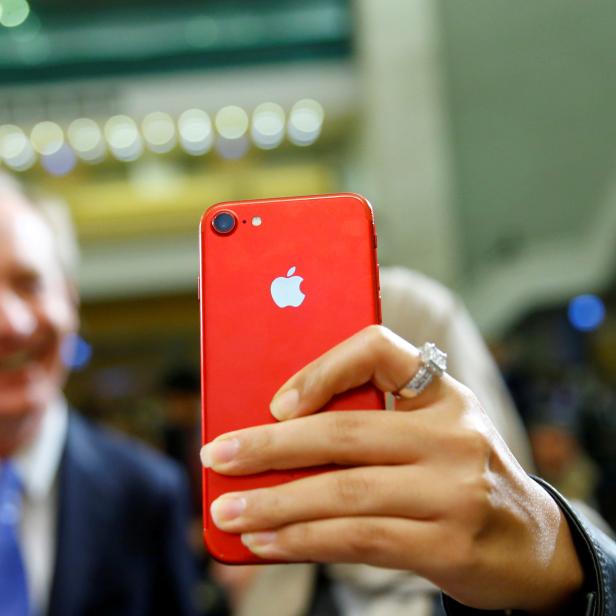 FILE PHOTO: An attendee takes a selfie with her iPhone in Geneva