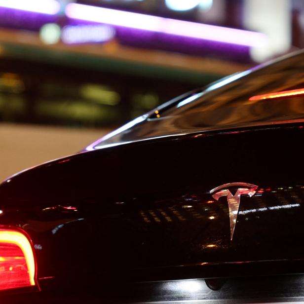 A Tesla logo is seen on a Parisian taxi car in Paris