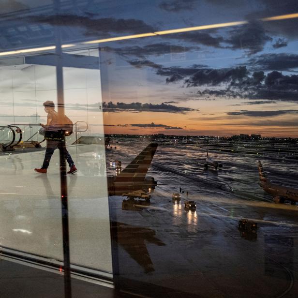 FILE PHOTO: A passenger arrives at the airport as Hurricane Elsa moves towards south Florida, in Miami