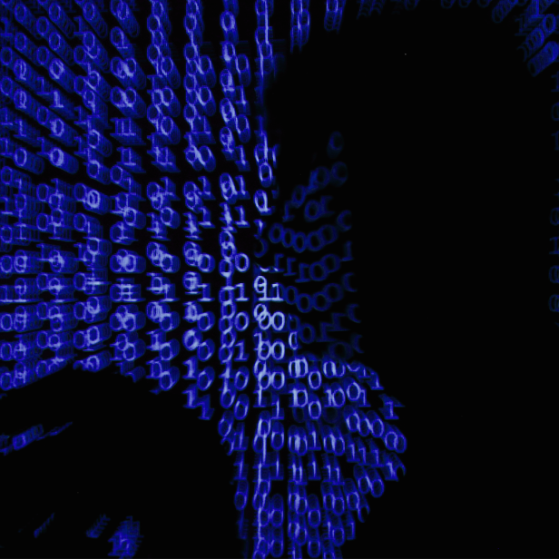 FILE PHOTO: A man holds a laptop computer as cyber code is projected on him in this illustration picture taken on May 13, 2017. REUTERS/Kacper Pempel/Illustration/File Photo