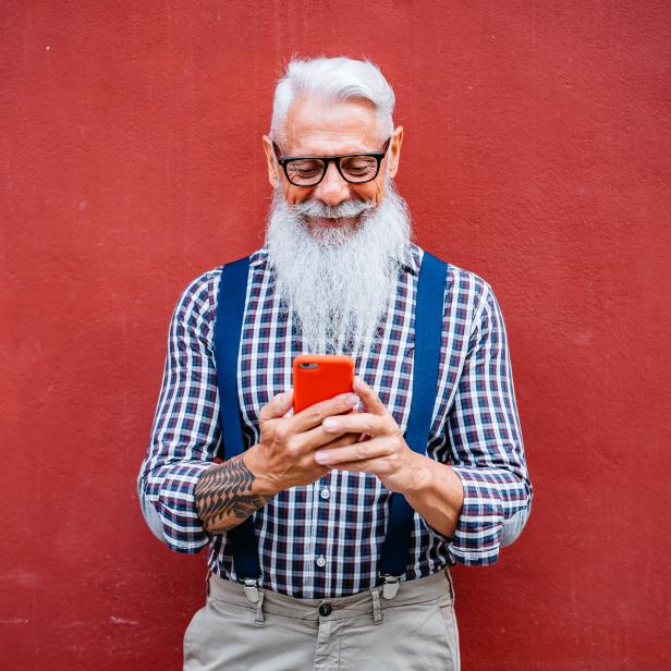 Handsome senior man using phone