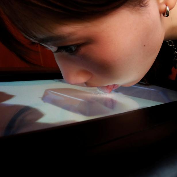 Demonstration of Taste the TV (TTTV), a prototype lickable TV screen that can imitate the flavours of various foods in Tokyo