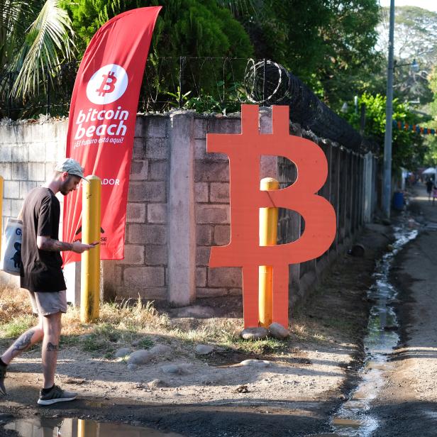 People participate in a meet up between local bitcoin users and foreigners at the closing of Adopting Bitcoin - A Lightning Summit in El Salvador at El Zonte Beach, in Chiltiupan