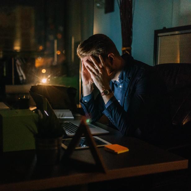 Tired businessman finishing work in office