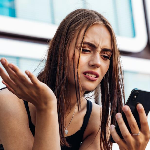 Bad News Young Woman Reading Messages on Mobile Phone