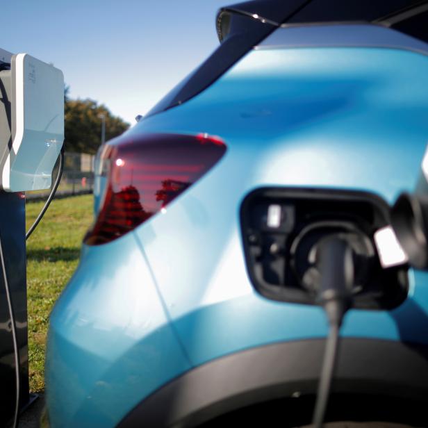 FILE PHOTO: A Renault wallbox charging station is used by a Renault Captur hybrid car at a dealership in Les Sorinieres