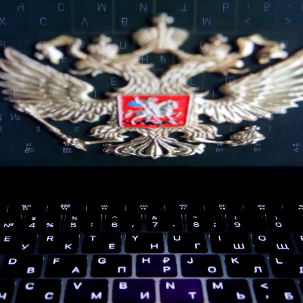 FILE PHOTO: The coat of arms of Russia is reflected in a laptop screen in this picture illustration