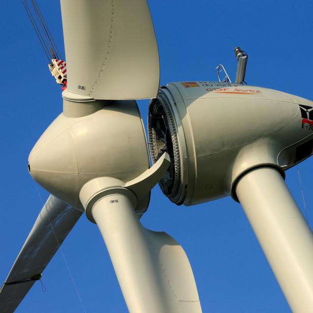 FILE PHOTO: A view shows the assembling of the rotor hub to the nacelle of an E-70 wind turbine manufactured by German company Enercon for La Compagnie du Vent during its installation at a wind farm in Meneslies, Picardie region