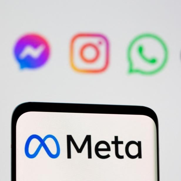 FILE PHOTO: Facebook's new rebrand logo Meta is seen on smartpone in front of displayed logo of Facebook, Messenger, Intagram, Whatsapp, Oculus in this illustration taken