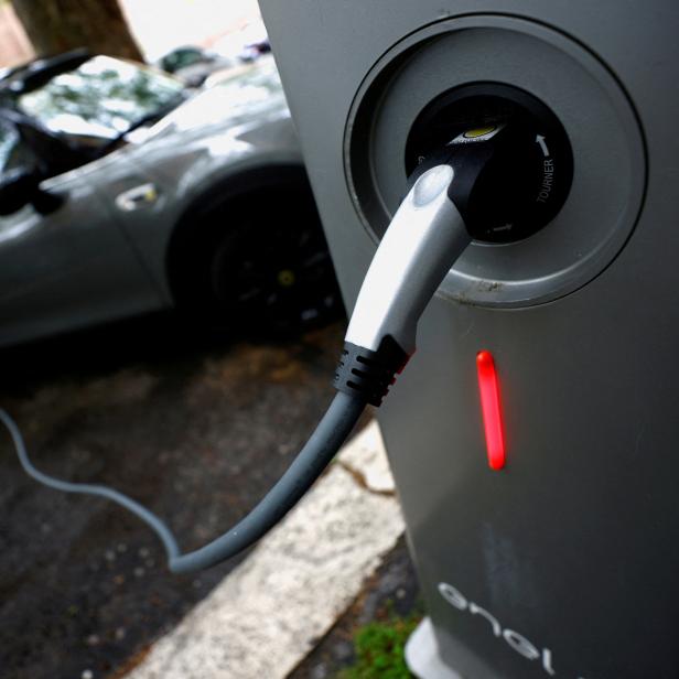 FILE PHOTO: An electric car is plugged in at a charging point for electric vehicles in Rome