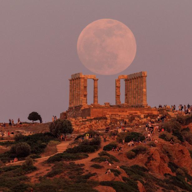 Flower Moon rises behind the Temple of Poseidon, before a lunar eclipse in Cape Sounion