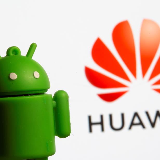 A 3D printed Android mascot Bugdroid is seen in front of the Huawei logo in this illustration