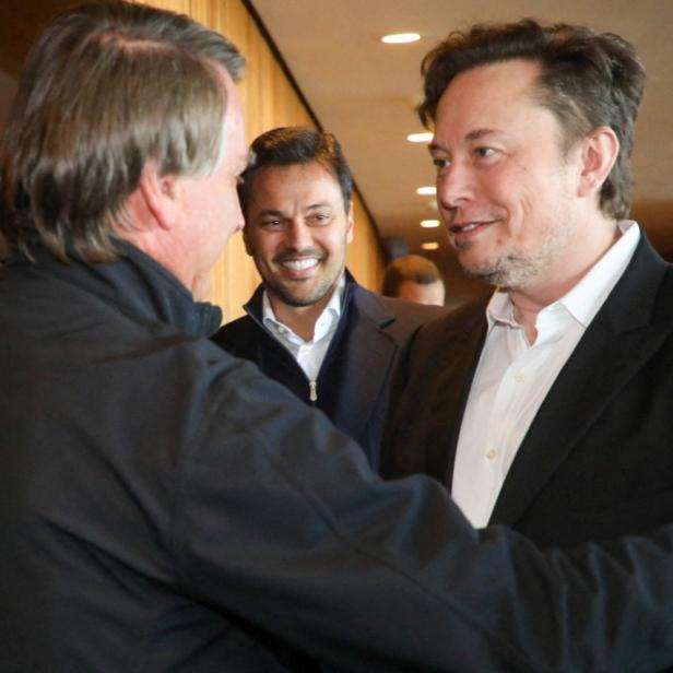 Brazil's President Jair Bolsonaro and Tesla CEO Elon Musk talk during a meeting in Porto Feliz city in Sao Paulo state