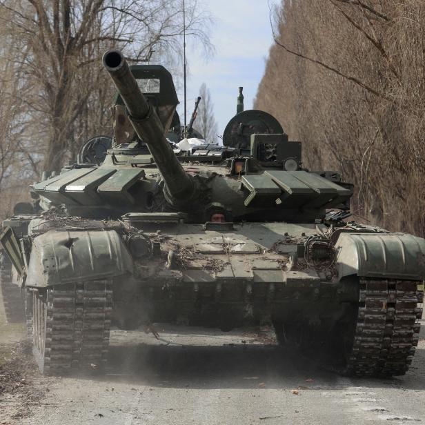 FILE PHOTO: Ukrainian service member drives a captured Russian T-72 tank in Lukianivka