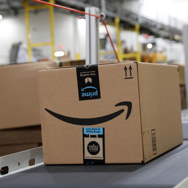 FILE PHOTO: Packaged merchandise is seen on a conveyer belt at the Amazon fulfillment center in Robbinsville