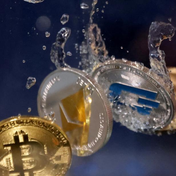 FILE PHOTO: Illustration shows representation of cryptocurrency Bitcoin, Ethereum and Dash plunging into water