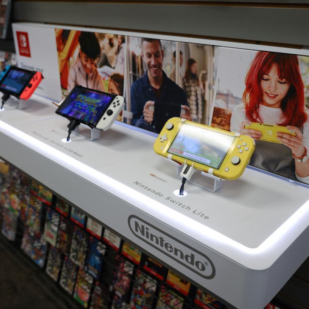 Different models of the Nintendo Switch are seen on display in a GameStop in Manhattan, New York