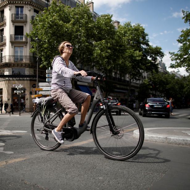 FILE PHOTO: A woman rides an electric bike as the country eases lockdown measures taken to curb the spread of the coronavirus disease (COVID-19) in Paris