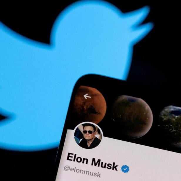 FILE PHOTO: A photo illustration shows Elon Musk's Twitter account and the Twitter logo