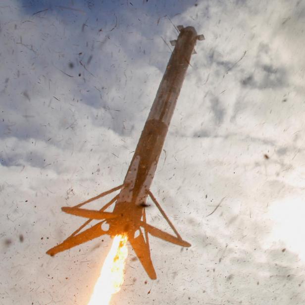 SpaceX Falcon Heavy rocket boosters descend before landing after launching on its mission with a classified payload for the U.S. Space Force at Cape Canaveral