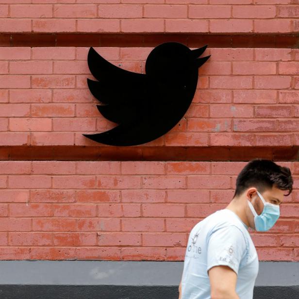 A person in a mask walks past the New York Twitter offices after they announced they will close their opened offices effective immediately in response to updated CDC guidelines during the outbreak of the coronavirus disease (COVID-19) in Manhattan