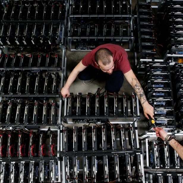 FILE PHOTO: Employees work on bitcoin mining computers at Bitminer Factory in Florence