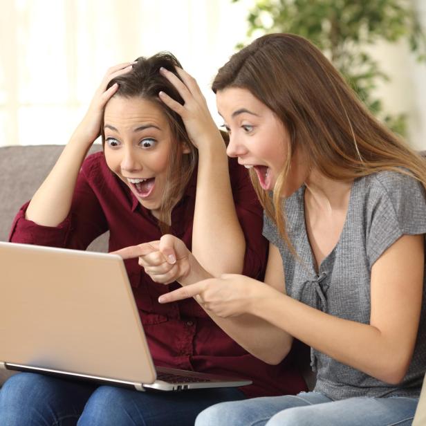 Astonished roommates watching media on line