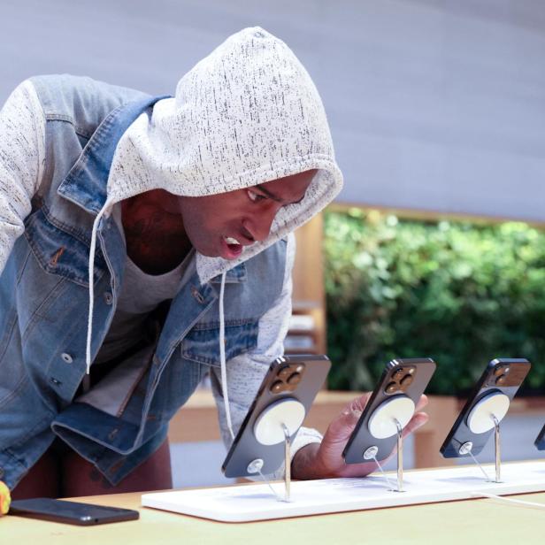 FILE PHOTO: A customer looks at the Apple iPhone 14 range at the Apple Fifth Avenue store in Manhattan, New York City