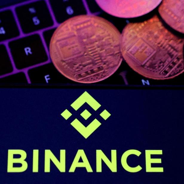 FILE PHOTO: Illustration shows Binance logo and representation of cryptocurrencies